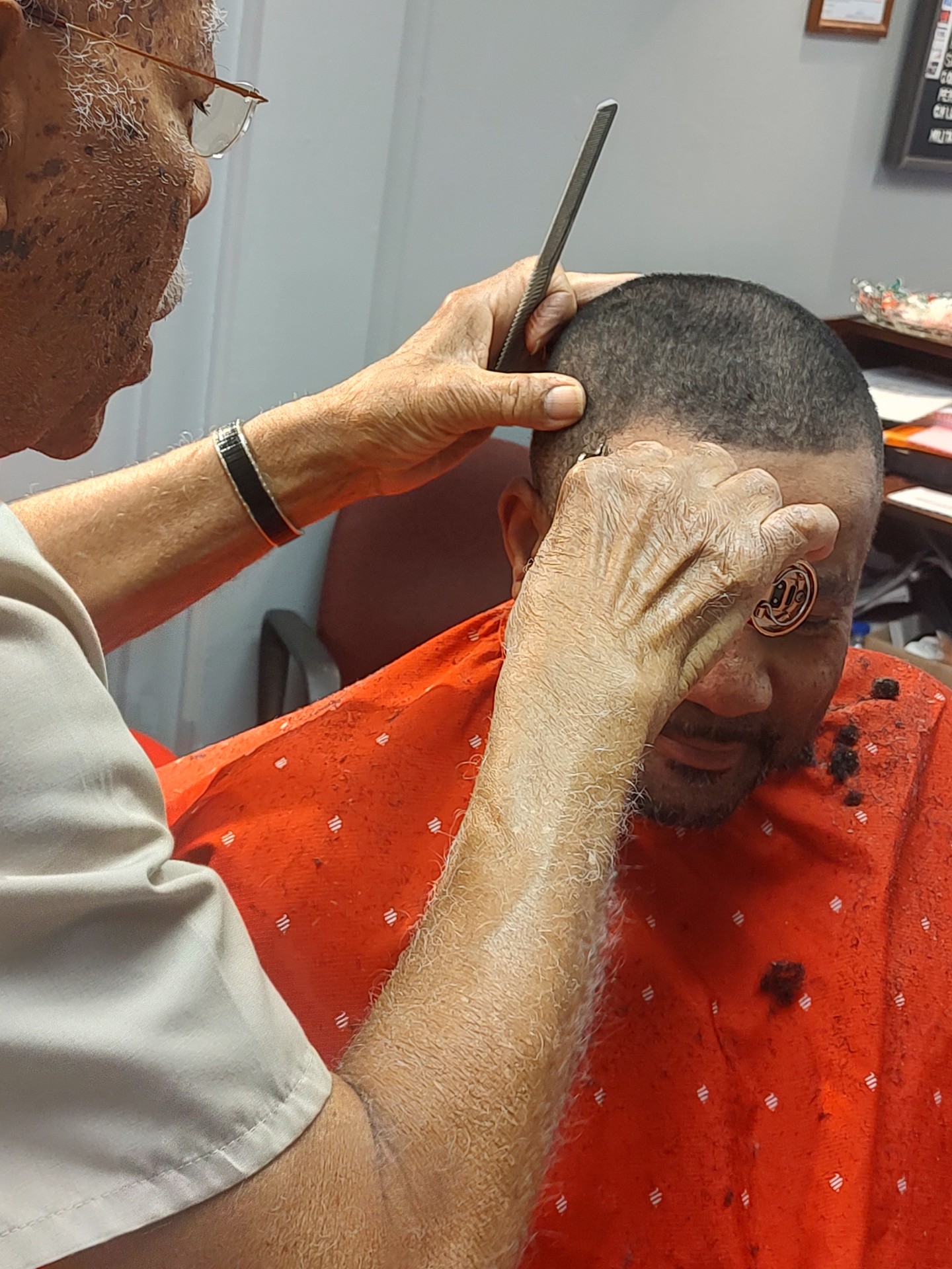 Mr. Johnson cutting a client's hair